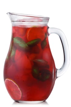 Strawberry basil lemonade in a glass pitcher, isolated