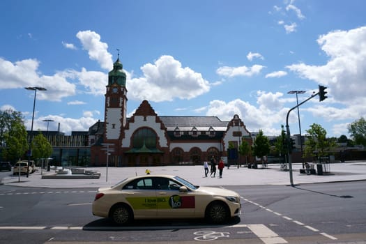 Bad Homburg, Germany - June 09, 2019: Tourists and travelers on the forecourt of the historic main train station on June 09, 2019 in Bad Homburg...