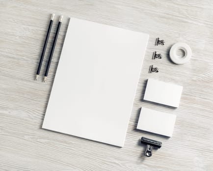 Blank branding stationery set on light wood table background. Corporate stationery template. Flat lay.