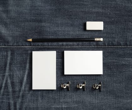 Photo of blank stationery set on denim background. Copy space for text. Flat lay.