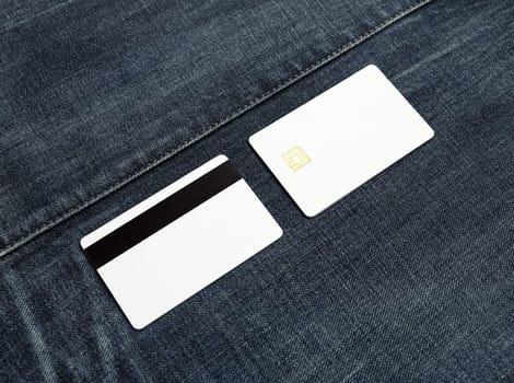 Two blank credit cards on denim background. Front and back view. Copy space for text.