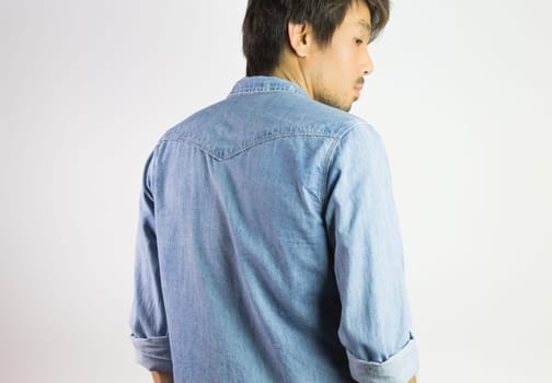 Portrait Man in Jeans Shirt or Denim Shirt Fashion in Back View. Jeans shirt or denim shirt fashion for men on grey background