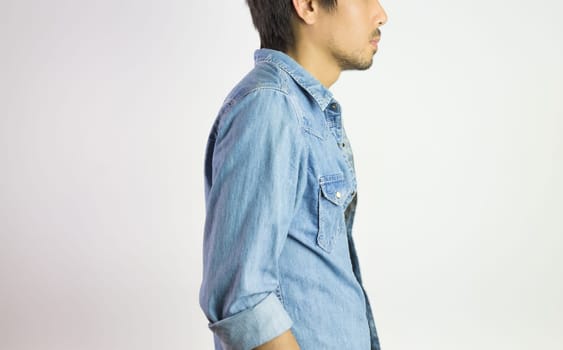Portrait Man in Jeans Shirt or Denim Shirt Fashion in Side View. Jeans shirt or denim shirt fashion for men on grey background