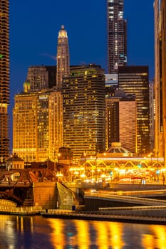 City of Chicago downtown and Chicago River sunset night in Chicago Illinois USA.