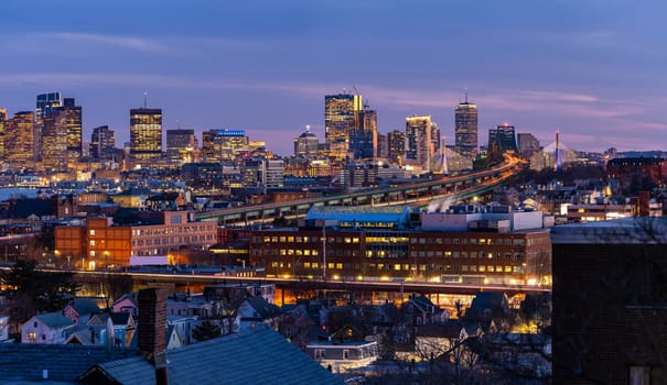 Panoramic of Boston Cityscape with highway trail to Boston MA USA at night.