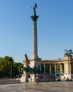 Budapest, Hungary - July 04, 2019: Heroes Square with Millenium Memorial and the horseman Memorial is one of the major squares in Budapest. Panorama with tourists and visitors.