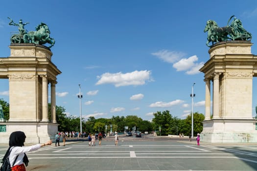 Budapest, Hungary - July 04, 2019: Heroes Square with Millenium Memorial and the horseman Memorial is one of the major squares in Budapest. Panorama with tourists and visitors.