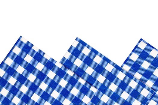 Closeup of a set of blue and white checkered kitchen cloth or napkin isolated on white background. Kitchen accessories. Macro.