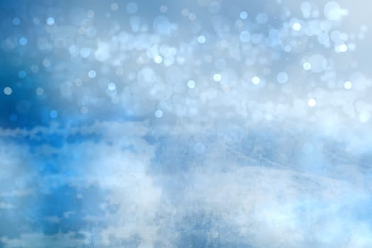 Abstract blurred festive winter christmas or Happy New Year background with shiny blue and white bokeh lighted snow landscape. Space for your design. Card concept.