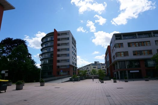 The town hall square in Bad Homburg with modern residential and commercial buildings as well as the pedestrian bridge over the Hessenring...