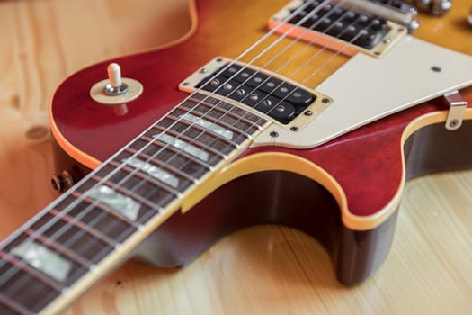 Electric guitar section with wood background