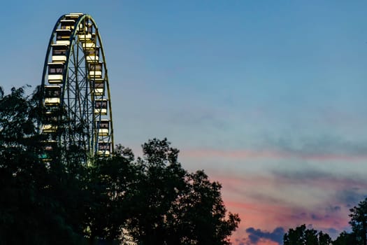 Budapest, Hungary - July 05, 2019: Luminous Ferris wheel in night city. Budapest Eye at night. Sziget Eye. The new Ferris Wheel opened on Erzsébet Square in mid-march 2017 and it will operate throughout the year.
