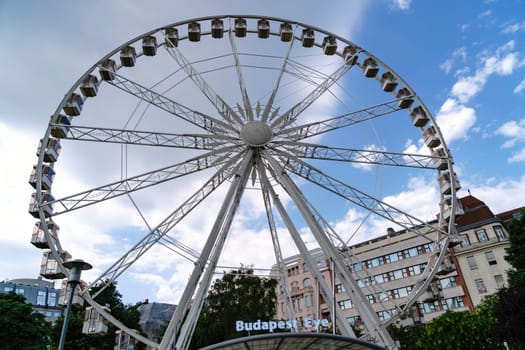 Budapest, Hungary - July 05, 2019: Luminous Ferris wheel in night city. Budapest Eye at night. Sziget Eye. The new Ferris Wheel opened on Erzsébet Square in mid-march 2017 and it will operate throughout the year.