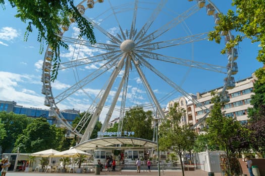 Budapest, Hungary - July 05, 2019: Luminous Ferris wheel in night city. Budapest Eye at night. Sziget Eye. The new Ferris Wheel opened on Erzsébet Square in mid-march 2017 and it will operate throughout the year.