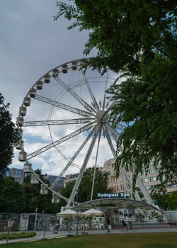 Budapest, Hungary - July 05, 2019: Luminous Ferris wheel in night city. Budapest Eye at night. Sziget Eye. The new Ferris Wheel opened on Erzsébet Square in mid-march 2017 and it will operate throughout the year.