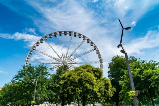 Budapest, Hungary - July 05, 2019: Luminous Ferris wheel in night city. Budapest Eye at night. Sziget Eye. The new Ferris Wheel opened on Erzsébet Square in mid-march 2017 and it will operate throughout the year.
