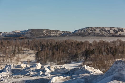 Dirty snow on the background of coal mine in winter