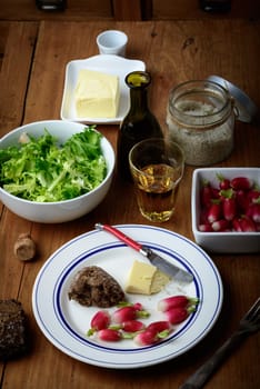 plate with radish and butter on a table