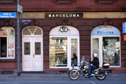 Frankfurt, Germany - July 06, 2019: A motorcyclist in front of the barber shop Barcelona at the Basle place on July 06, 2019 in Frankfurt...