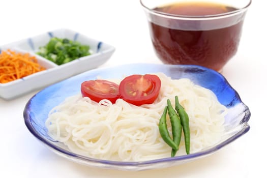 Japanese somen noodles in a glass plate with Mentuyu on white background