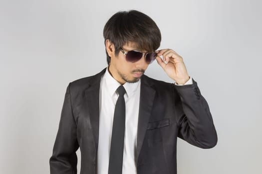 Portrait Businessman in Black Suit Touching Eyeglasses or Eyewear. Portrait businessman wear white shirt and suit in smart pose style