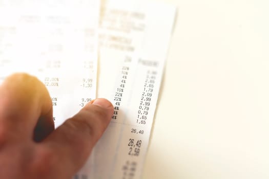 checking a receipt by analyzing the numbers, expenses and profits. Business and finance concept. Home financial balance sheet