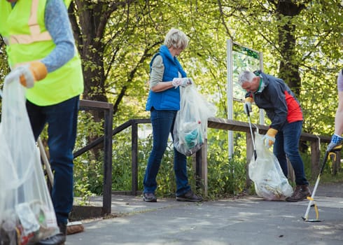 A group of people participating in a city clean-up together.