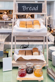 variety of bakery bread and rolls station in buffet line