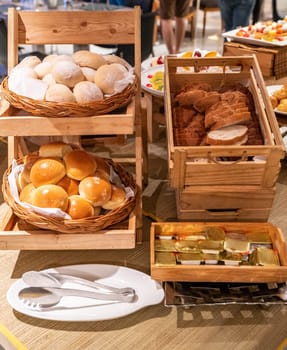 variety of bakery bread and rolls station in buffet line