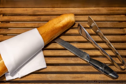 French bread and knife on wooden board