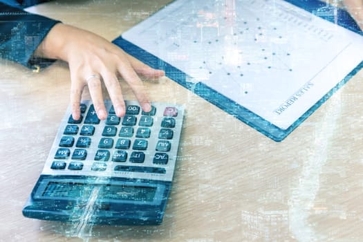 Double exposure of businesswoman hand with calculator and New york skyline building background
