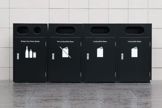 Recycle bins for rubbish, recycling and garden waste, over white wall background