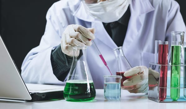 Researcher with glass laboratory chemical test tubes with liquid for analytical , medical, pharmaceutical and scientific research concept.
