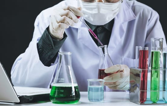 Researcher with glass laboratory chemical test tubes with liquid for analytical , medical, pharmaceutical and scientific research concept.