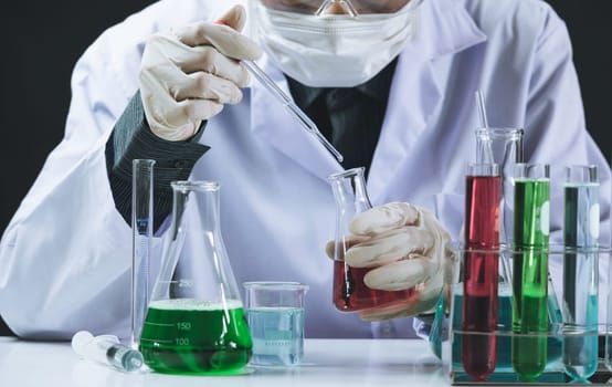 Researcher with glass laboratory chemical test tubes with liquid for analytical , medical, pharmaceutical and scientific research concept.