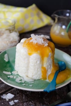Exotic vegan rice pudding with coconut and mango sauce