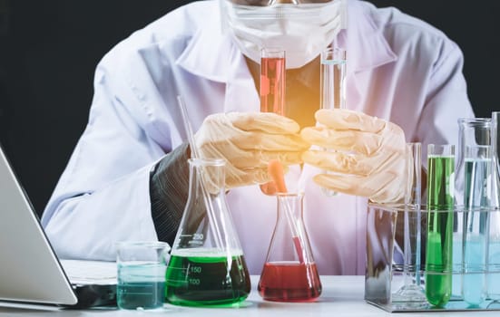 Researcher with glass laboratory chemical test tubes with liquid for analytical , medical, pharmaceutical and scientific research concept.