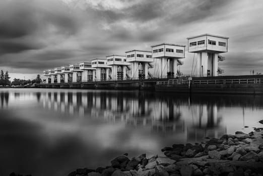 Water barrier with cloud sky in sunset and river long exposure style, Black and white and monochrome style