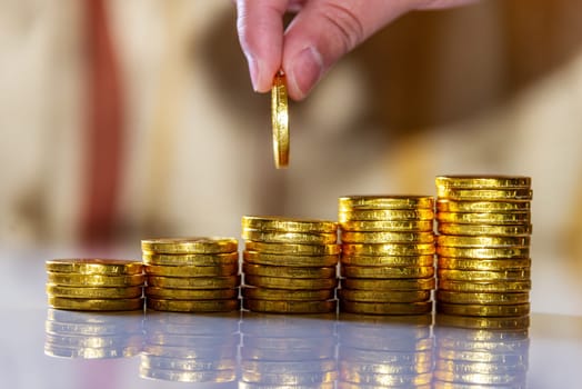 Save money and account banking for finance business concept, Hand with coin money on blurred background