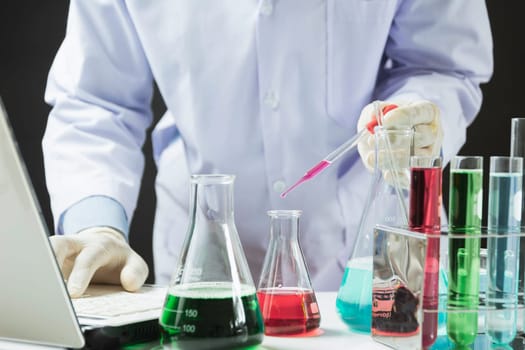 Researcher with glass laboratory chemical test tubes with liquid for analytical , medical, pharmaceutical and scientific research concept.