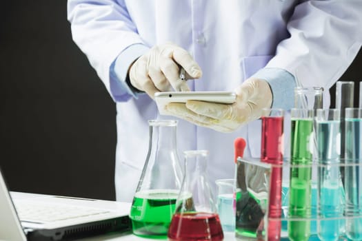 Researcher with glass laboratory chemical test tubes with liquid for analytical , medical, pharmaceutical and scientific research concept.
