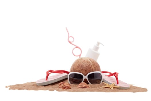 Beach accessories: flip flops, sunglasses, sunscreen, seashells and coconut drink, lying on the sand on white background. Concept of sea vacation and travel. Summer background, Protection from uv
