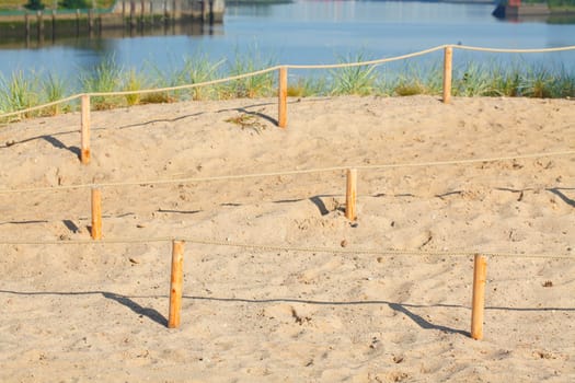 Sand dunes with path and fence, Germany, Europe..