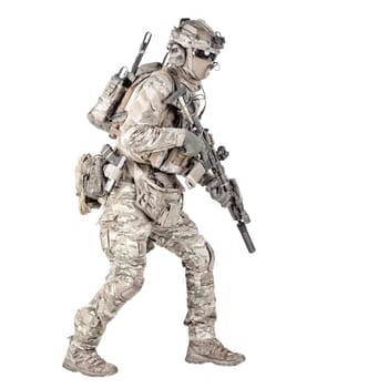 Army soldier, equipped infantryman, airsoft player in camouflage battle uniform, helmet and tactical radio headset jumping, running with assault rifle in hand studio shoot isolated on white background