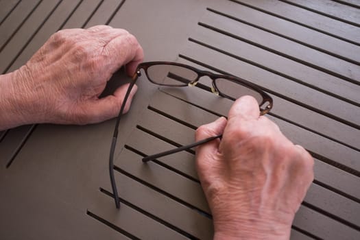 Close-up of the hands of an elderly man suffering from CIDP, an autoimmune disease of the nervous system. Copy space.