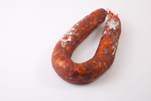 Red spanish chorizo sausage. Isolated over white background