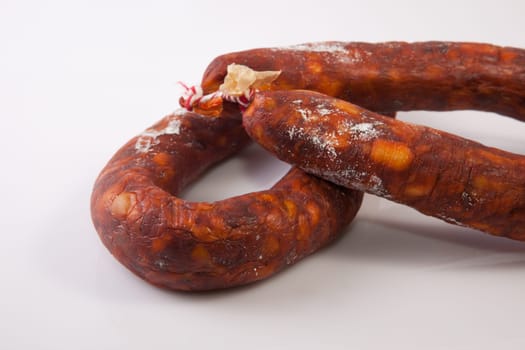 Two red spanish chorizos. Isolated over white background