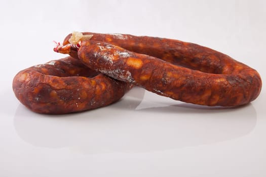 Two red spanish chorizos. Isolated over white background