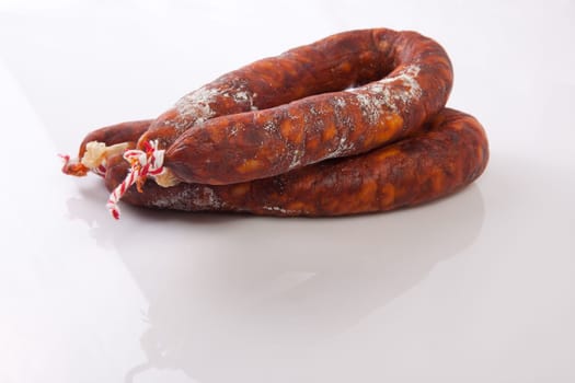 Two red spanish chorizos. Isolated over white background