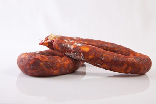 Two red spanish chorizos. Isolated over white background